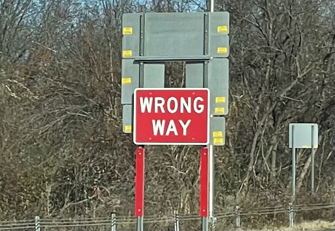 Sign on a highway saying "Wrong Way."